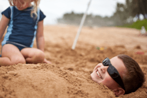Being buried in the sand is a great outdoor sensory activity for the beach