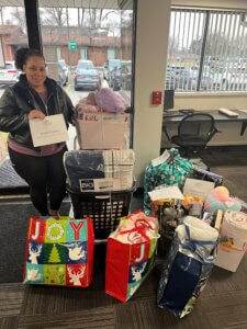 Danielle receiving gifts for a family in need
